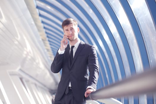 Businessman talking on the phone in modern building