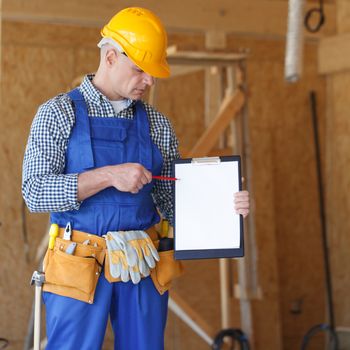 Worker pointing at a clipboard with blank paper, contract concept