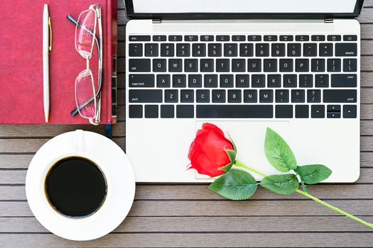 Top view with copy space valentine's day, Office desk table with laptop,notebook, coffee cup,red rose