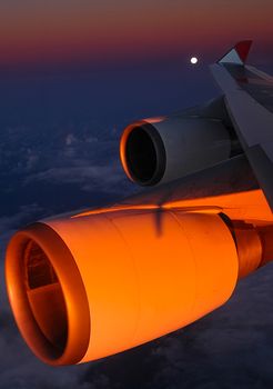 The view from the window of a passenger plane during the flight, the wing of the turbine engine of the aircraft.