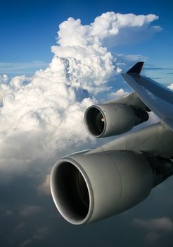 The view from the window of a passenger plane during the flight, the wing of the turbine engine of the aircraft.