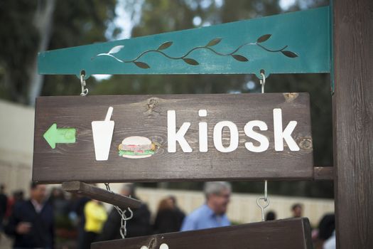 Kiosk sign with a hamburger made of carved wood