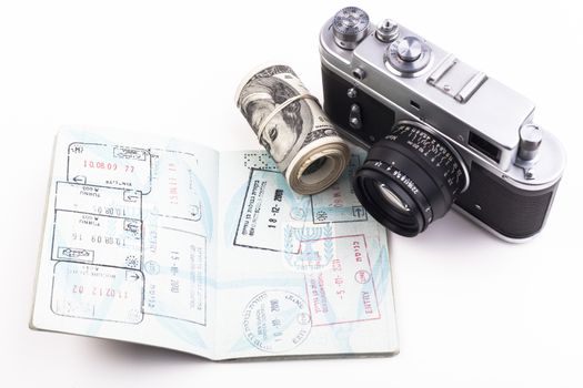 Open Israeli  passport full with visa with an old camera and dollars isolated on white background