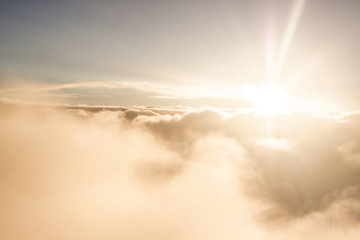 Sunrise above clouds during a flight bright light and colors