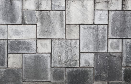 Black rectangular stone wall closeup