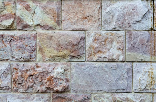 Colored rectangular stone wall closeup