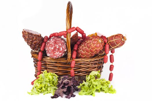 Basket full with salami and green salad aside