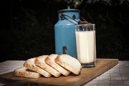 Milk and bread on a wood cutting board