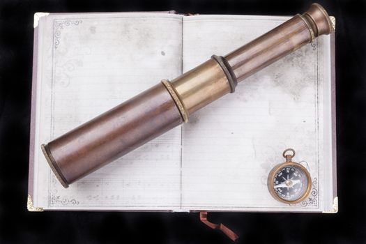 Jurney planing with an old telecsope and compass on an old notebook