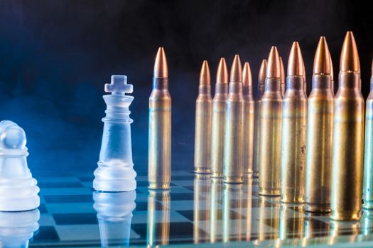 Confruntation bewteen chess kink and a bullet with blue smoke in the background