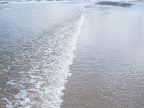 Ripple texture, with foam at the seaside, in shallow sea.