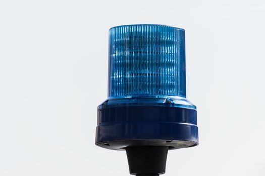 Detail shot of a blue light on a police car on the street