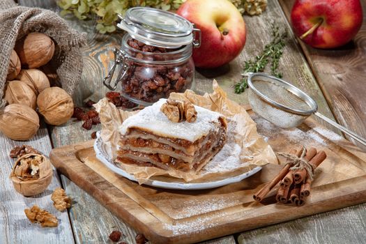 Cake, tea and apples on a fabric background