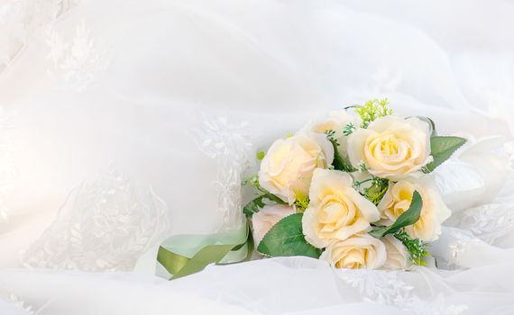 Beautiful bouquet of fresh roses on a white drapery