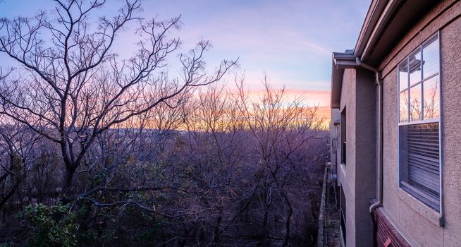 Panorama view typical park side apartment complex during winter sunrise with dramatic cloud reflection on windows. Aerial view of apartment building in Texas, America