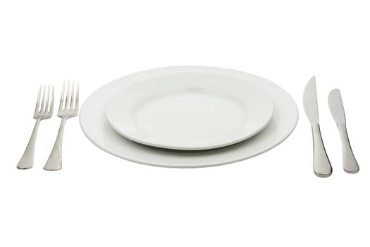 Place setting with high-gloss plate, knife & fork. Isolated on white. 