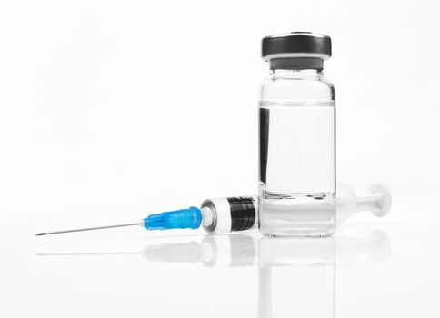 medical ampules and syringe on white 