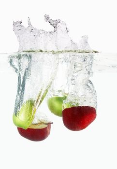 Apples falls deeply under water with a big splash. 