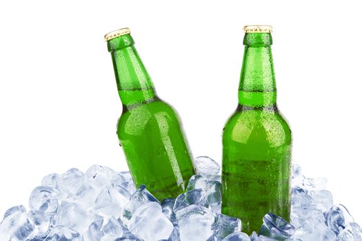 Two bottles of beer on ice isolated on white background 