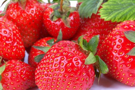 Strawberries with leaves and flower as a background