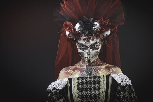 Santa Muerte Young Girl with Artistic Halloween Makeup and with Sculls in her Hair