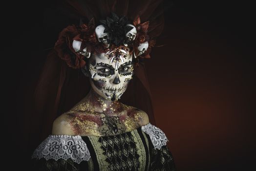 Santa Muerte Young Girl with Artistic Halloween Makeup and with Sculls in her Hair