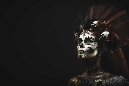 Santa Muerte Young Girl with Artistic Halloween Makeup and with Sculls in her Hair