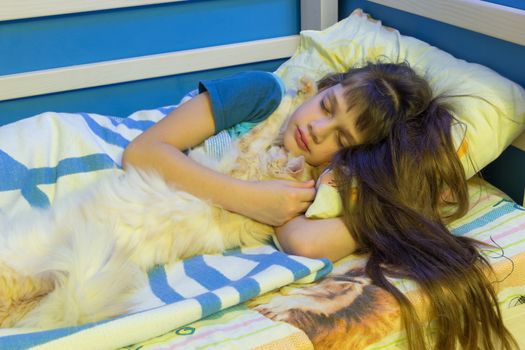 Girl sleeping in a crib with a fluffy cat