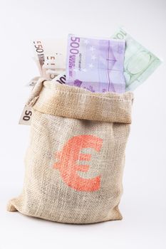 A bag full with euro banknotes with euro sign on the bag isolated on white background