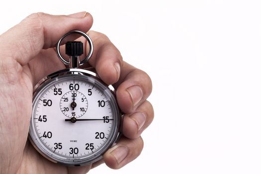 Retro analog stopwatch in a hand pointing on 15 seconds isolated on white background