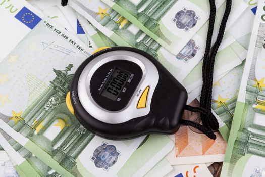 Black Digital stopwatch on various euro banknotes