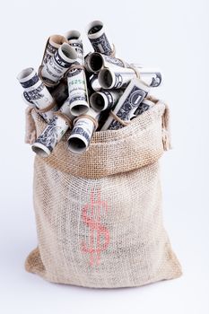 Dollars rolled up with rubber band in Sack brown isolated on white background