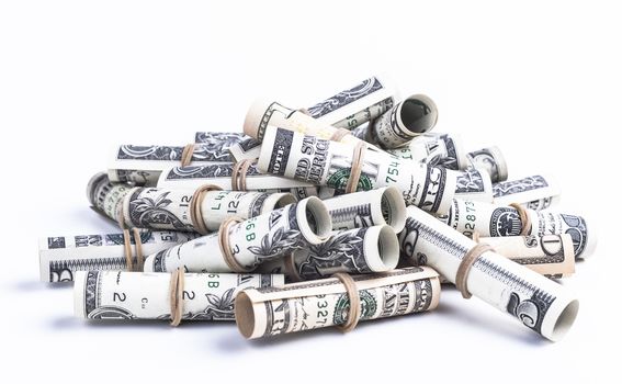 Pile of rolled dollars with elastic band isolaten on white background