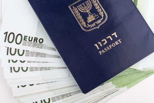 Israeli passport closeup with euro banknotes in the middle
