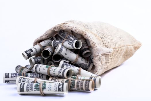 Dollars rolled up with rubber band in Sack brown isolated on white background