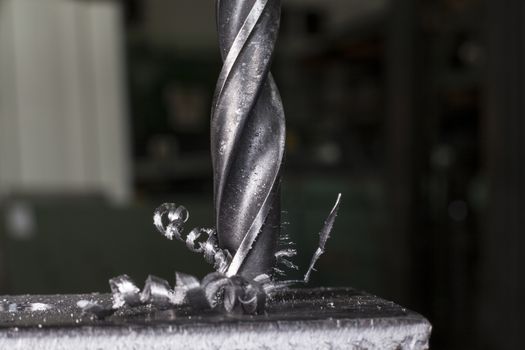 Metal drilling closeup in metal workshop