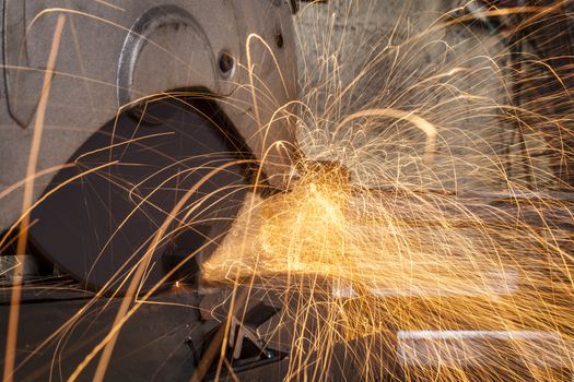 Metal cutting close-up with electrical grinder with sparks 