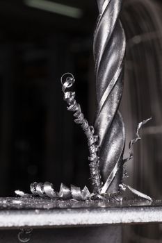 Metal drilling closeup in metal workshop