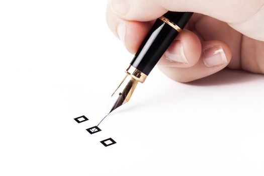 Female hand holding fountain pen and Marking  in middle check-box