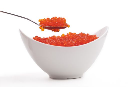Red caviar in a white bowl and silver spoon isolated  on white  background