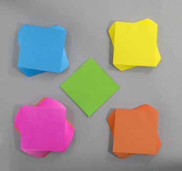 colorful sticky notes in different sizes shapes and colors on grey  background