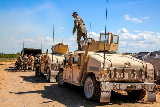 NATO Hummer military vehicles. Soldier on armored Hummer. International Military Training "Saber Strike 2017", Adazi, Latvia, from 3 to 15 June 2017. US Army Europe-led annual International military exercise Saber Strike Field Training Exercise in Latvia.
