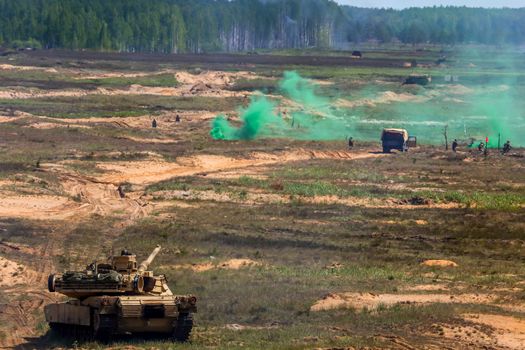 Tank Abrams shoot. Explosion, smoke and military vehicles. International Military Training "Saber Strike 2017", Adazi, Latvia, from 3 to 15 June 2017. US Army Europe-led annual International military exercise Saber Strike Field Training Exercise in Latvia;

Tanki un sprādziena dūmi Ādažu poligonā. Tanks Abrams šauj. Kaujas imitācija. Starptautiskās militārās mācības "Saber Strike 2017". Militārās mācības Ādažu poligonā. starptautiskās militārās mācības Baltijas valstu un Polijas teritorijā.