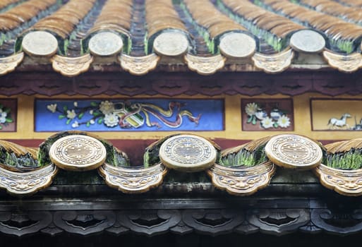 Close up of roof of Buddhist temple, Vietnam, with longevity symbols