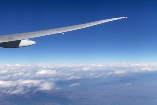 Wing of an airplane and the land below