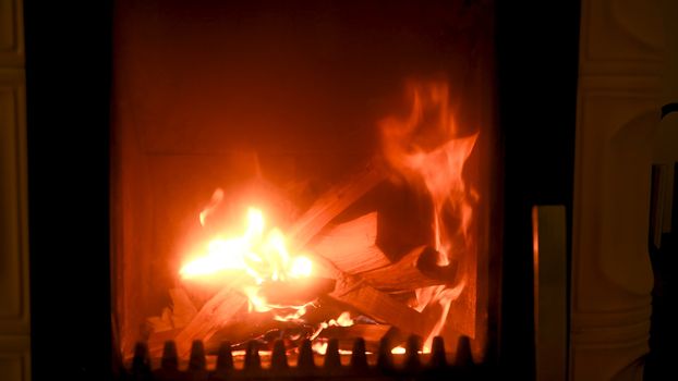 Fire in stove, close up, firewood burning, detail interior scene, winter concept