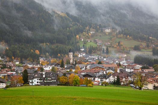 village in fog in late autumn, Castelrotto, Dolomites, Italy
