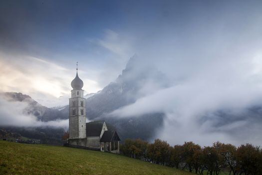 san Valentino church on a foggy late autumn day, Siusi allo Sciliar, Castelrotto, Dolomites, Italy