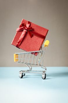 huge red gift box in shopping cart - online shopping