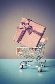 huge red gift box in shopping cart - online shopping